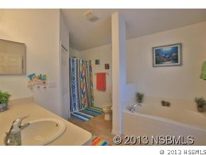 2032 Mango Tree Drive Edgewater, FL 32141 - Photo 14 of 24 a bathroom with a tub sink and mirror