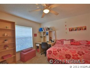 2032 Mango Tree Drive Edgewater, FL 32141 - Photo 15 of 24 a bedroom with a bed and dresser