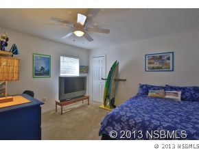 2032 Mango Tree Drive Edgewater, FL 32141 - Photo 16 of 24 a bedroom with furniture and a window