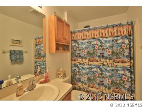 2032 Mango Tree Drive Edgewater, FL 32141 - Photo 17 of 24 a bathroom with a sink and a mirror