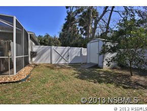 2032 Mango Tree Drive Edgewater, FL 32141 - Photo 2 of 24 a backyard of a house with a yard and garage