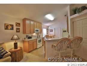 2032 Mango Tree Drive Edgewater, FL 32141 - Photo 8 of 24 a kitchen with sink a stove and cabinets