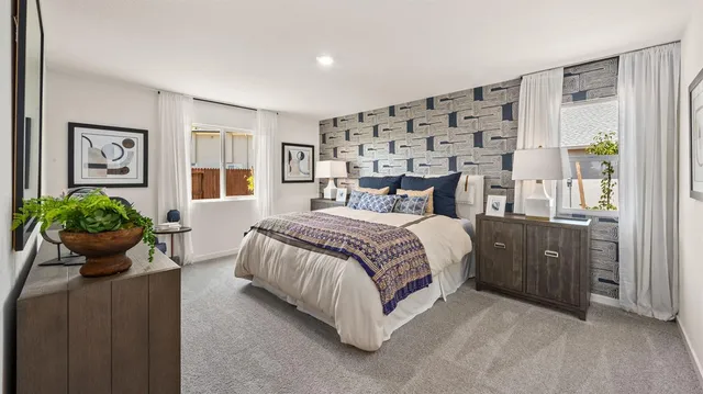 a bedroom with a bed potted plant and a window