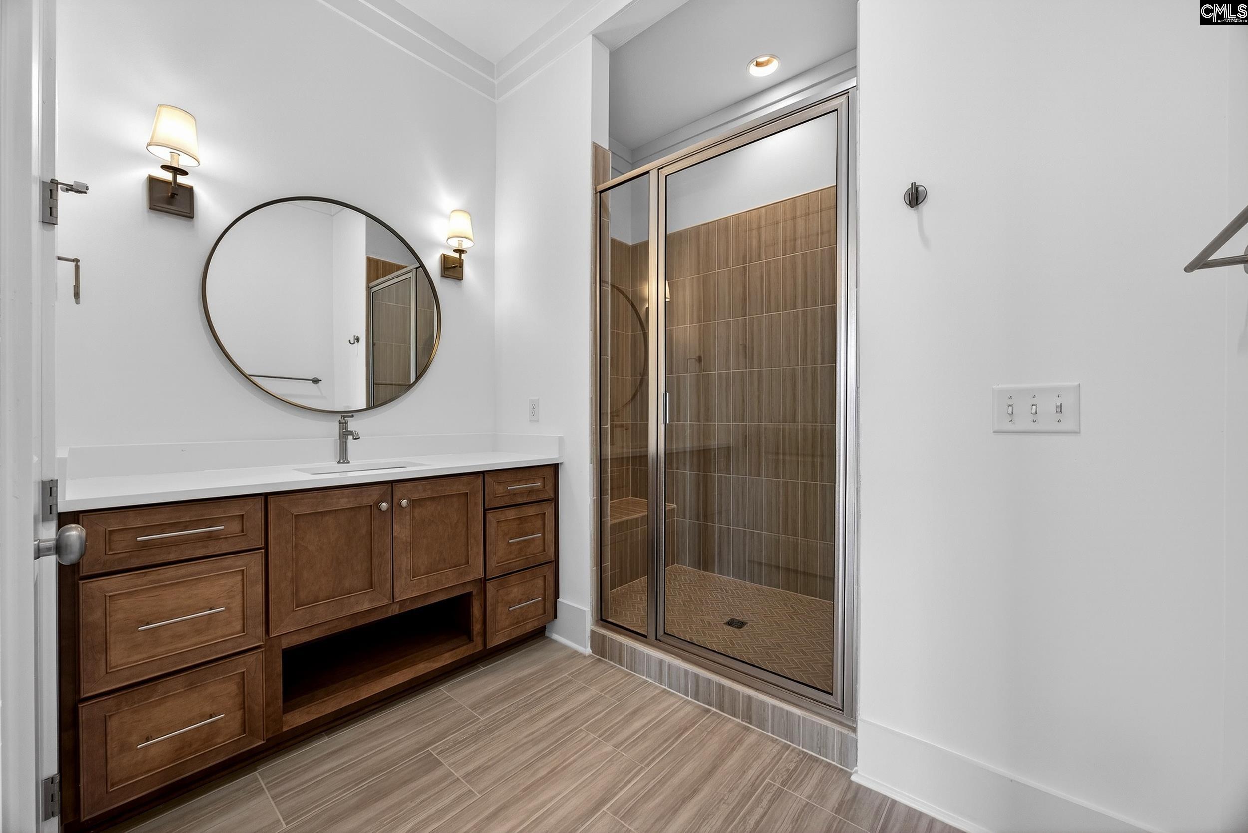 1318 Long Grove Way Lexington, SC 29072 - Photo 59 of 90 a bathroom with a sink a mirror and a shower