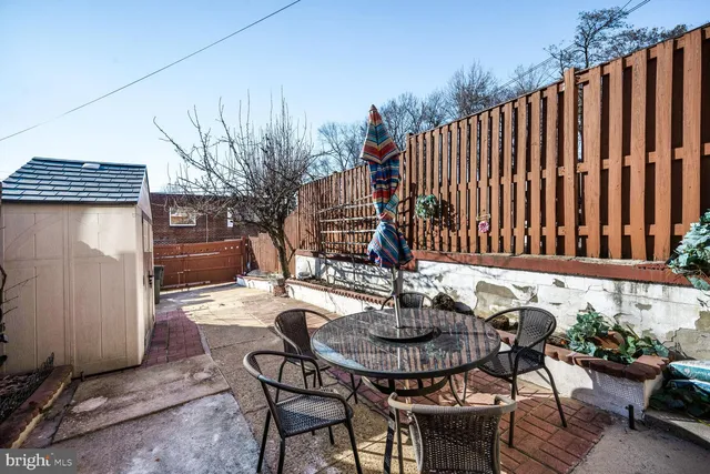 a view of a patio with couches table and chairs and potted plants