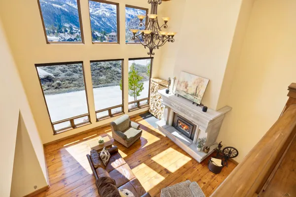 a living room with furniture and a floor to ceiling window
