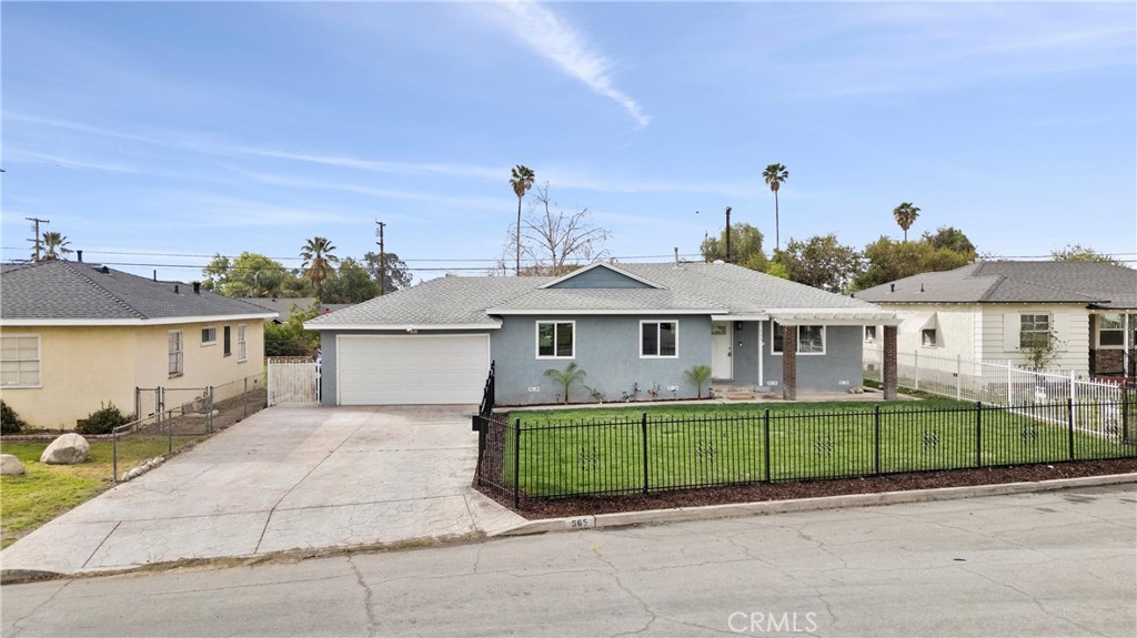 665 West Grove Street Rialto, CA 92376 - Photo 1 of 1 front view of a house with a garden