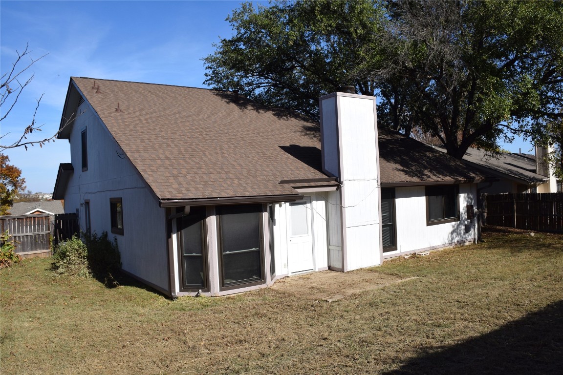 1911 Klattenhoff Drive Austin, TX 78728 - Photo 14 of 14 Rear view of property with roof with shingles and a chimney