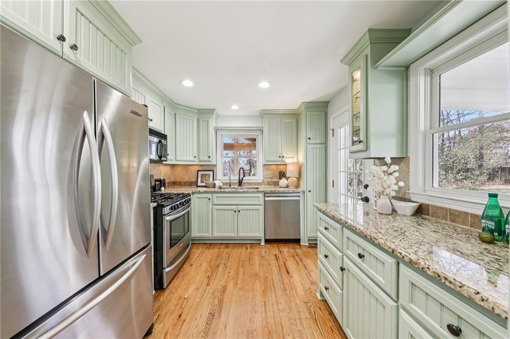 1173 Willivee Drive Decatur, GA 30033 - Photo 15 of 35 a kitchen with granite countertop appliances a sink a refrigerator and cabinets