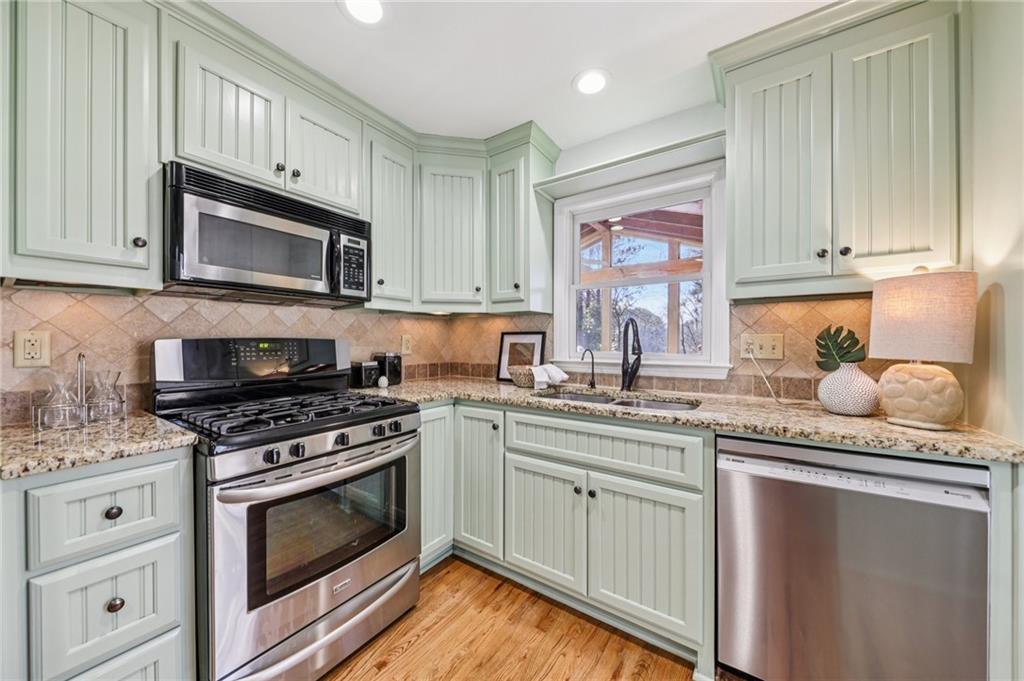 1173 Willivee Drive Decatur, GA 30033 - Photo 16 of 35 a kitchen with granite countertop cabinets stainless steel appliances and a sink