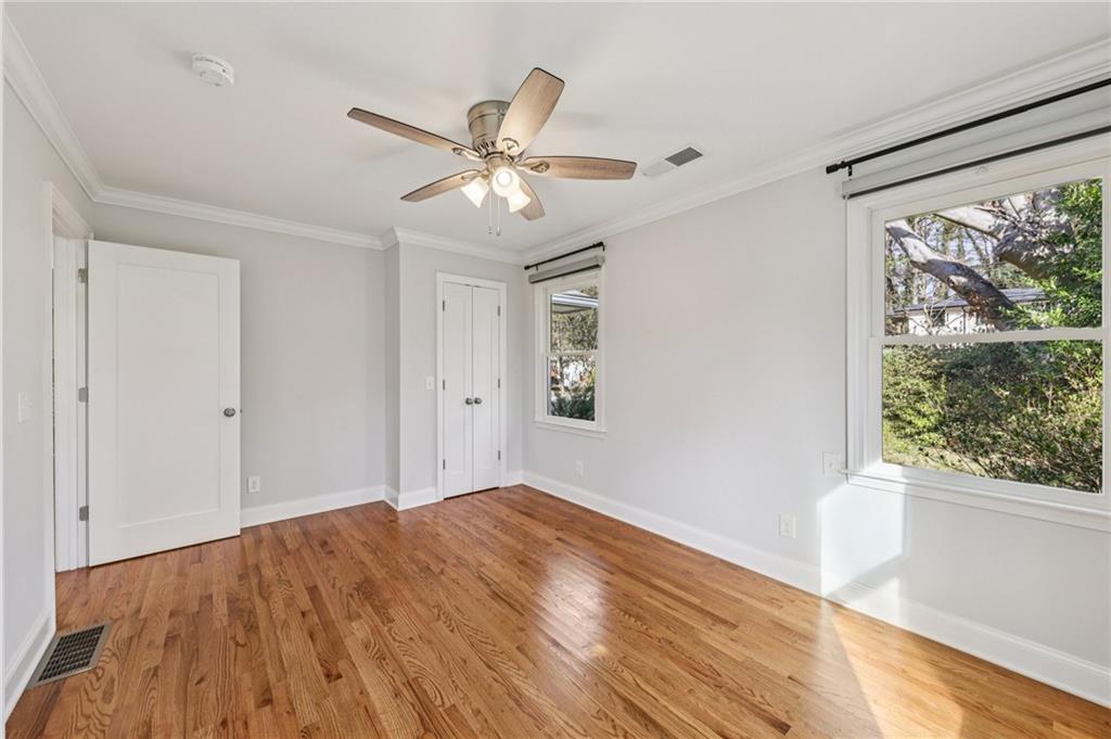1173 Willivee Drive Decatur, GA 30033 - Photo 22 of 35 a view of empty room with wooden floor and fan