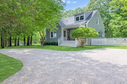 a house with a yard and a large tree