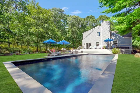 a view of swimming pool with outdoor seating and yard