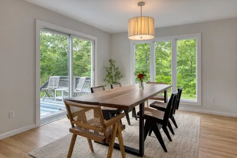 a view of a dining room with furniture window and outside view