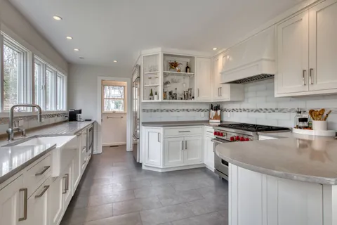 a kitchen with stainless steel appliances granite countertop a stove sink and cabinets