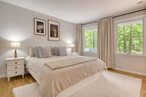a bedroom with a bed and a window