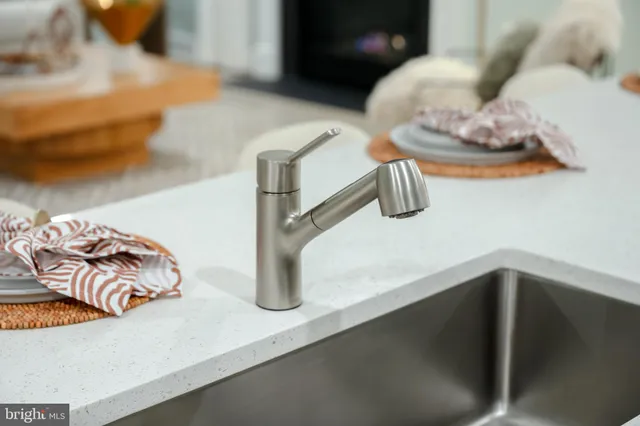 a kitchen with sink refrigerator and stove