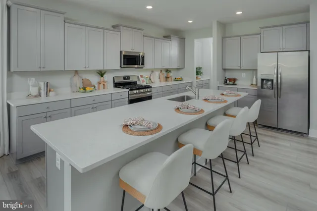 a kitchen with a dining table and chairs