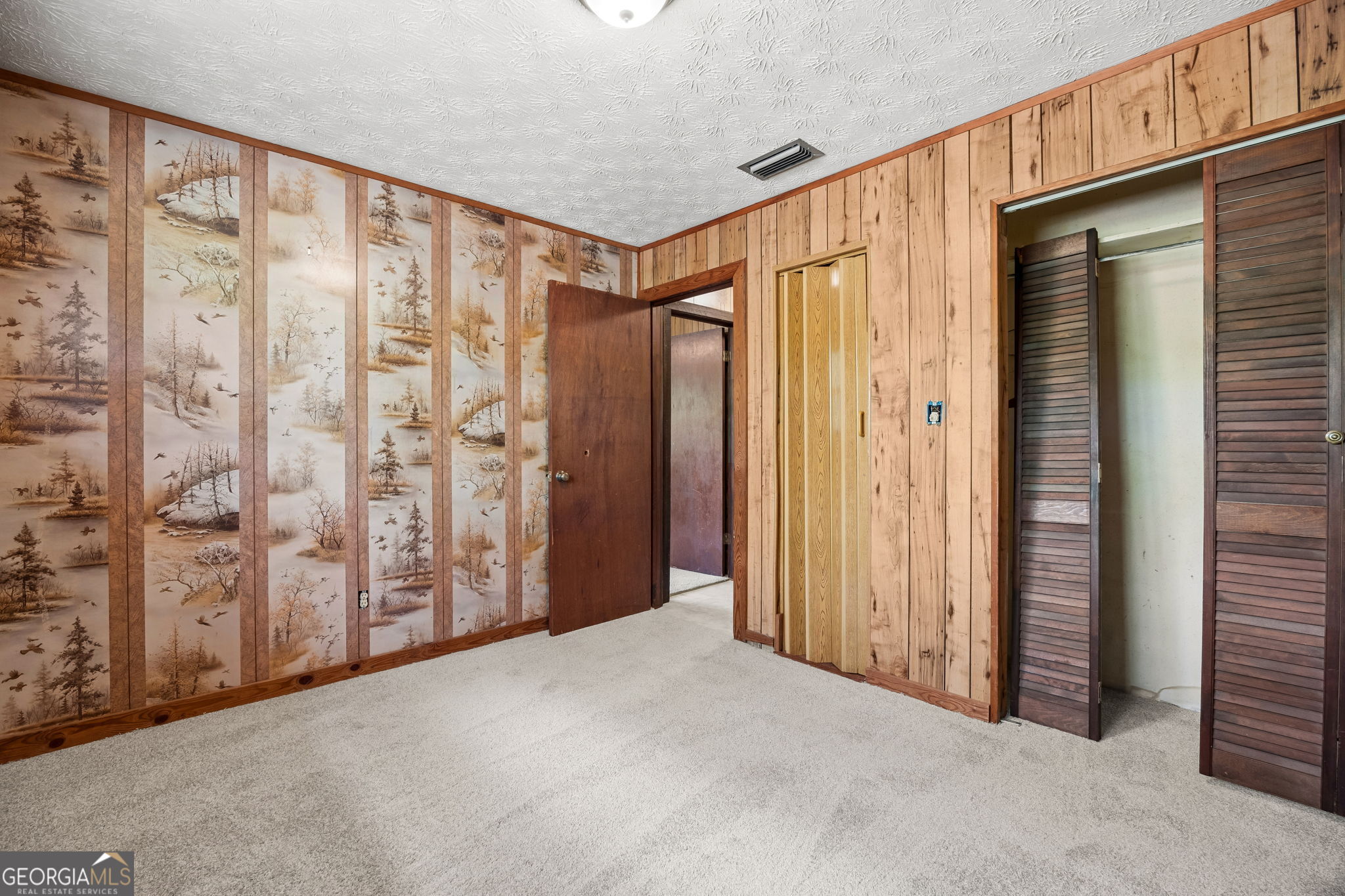 14 Graham Lane St. George, GA 31562 - Photo 15 of 21 a view of a hallway with wooden walls