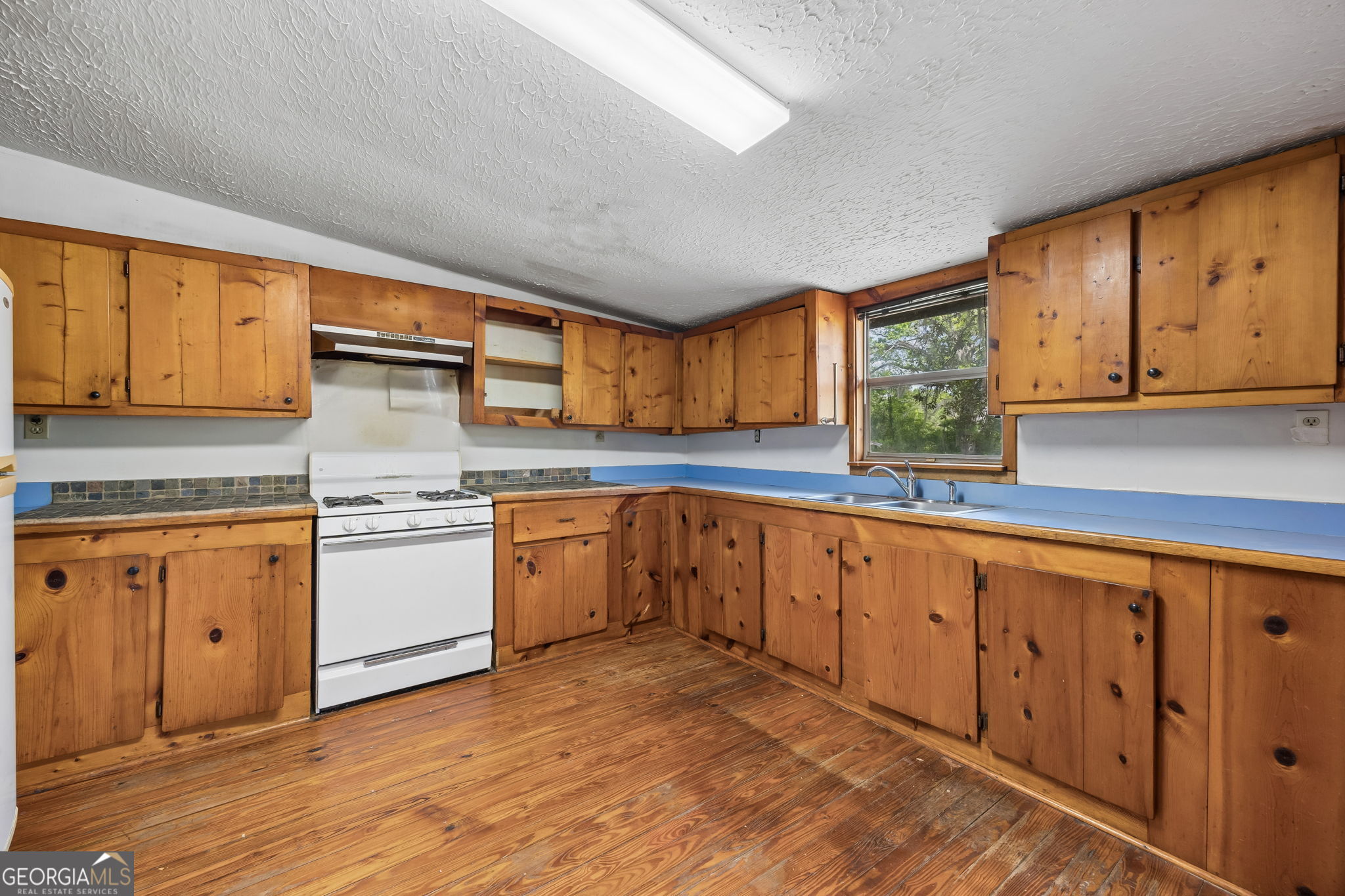 14 Graham Lane St. George, GA 31562 - Photo 8 of 21 a kitchen with granite countertop wooden cabinets stainless steel appliances and a sink
