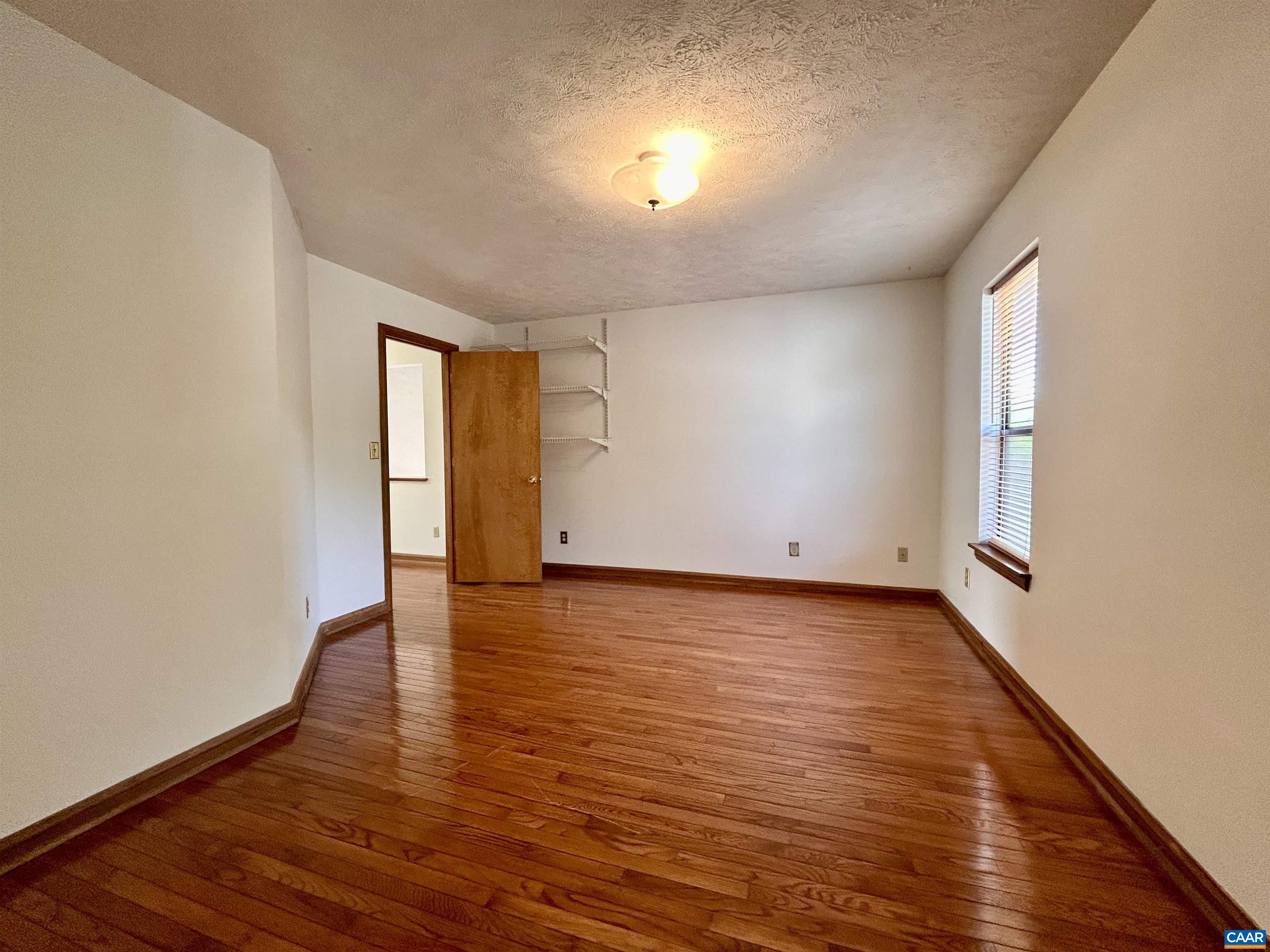 1 Old Mill Court Palmyra, VA 22963 - Photo 14 of 19 a view of an empty room with wooden floor and a window