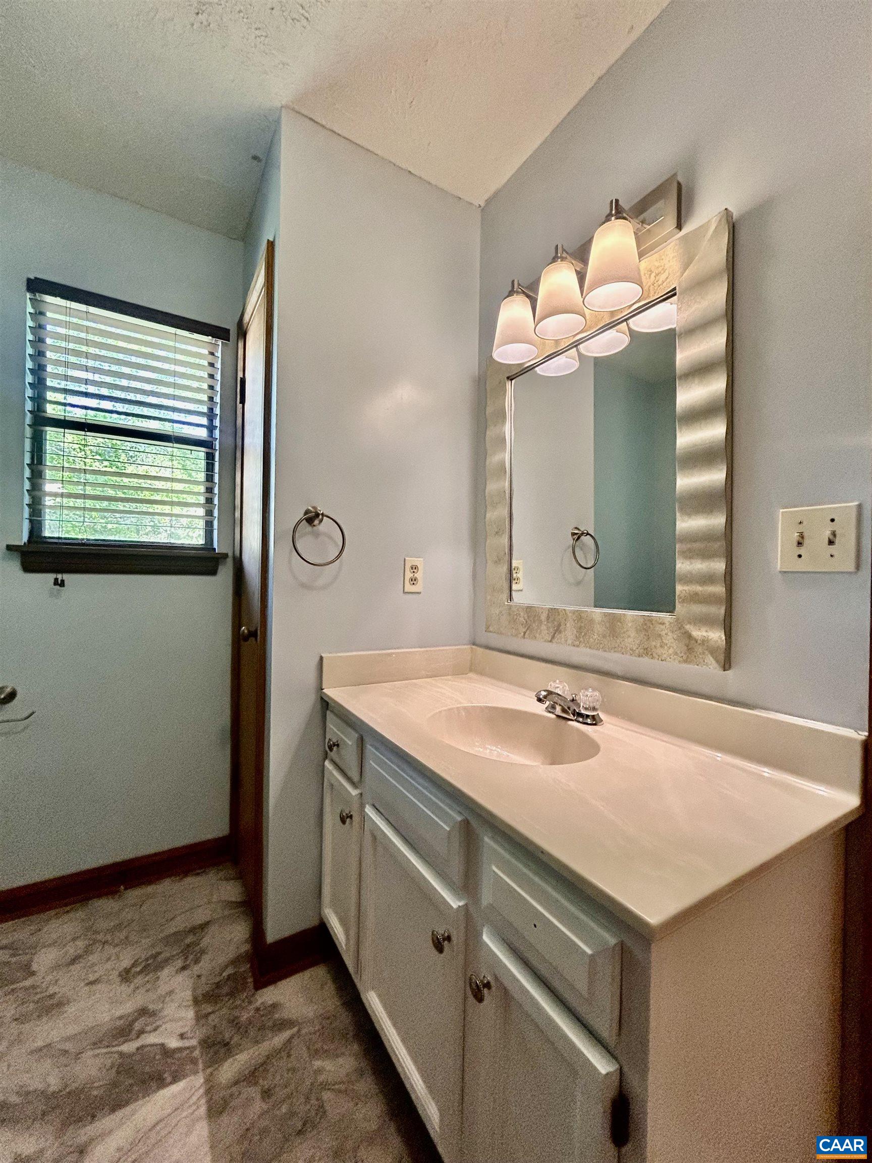 1 Old Mill Court Palmyra, VA 22963 - Photo 16 of 19 a bathroom with a sink vanity and a mirror