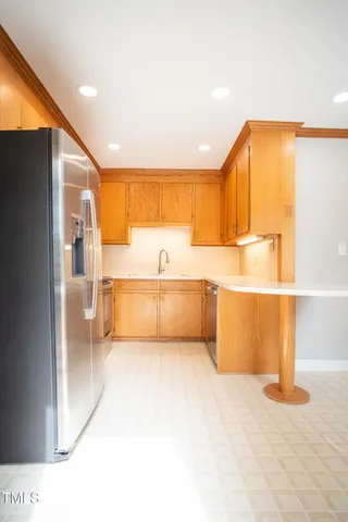 a view of a kitchen with a sink and a refrigerator