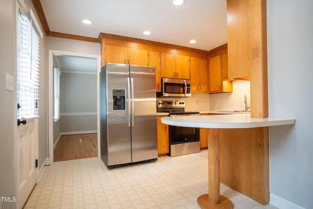 a kitchen with stainless steel appliances a refrigerator sink and microwave