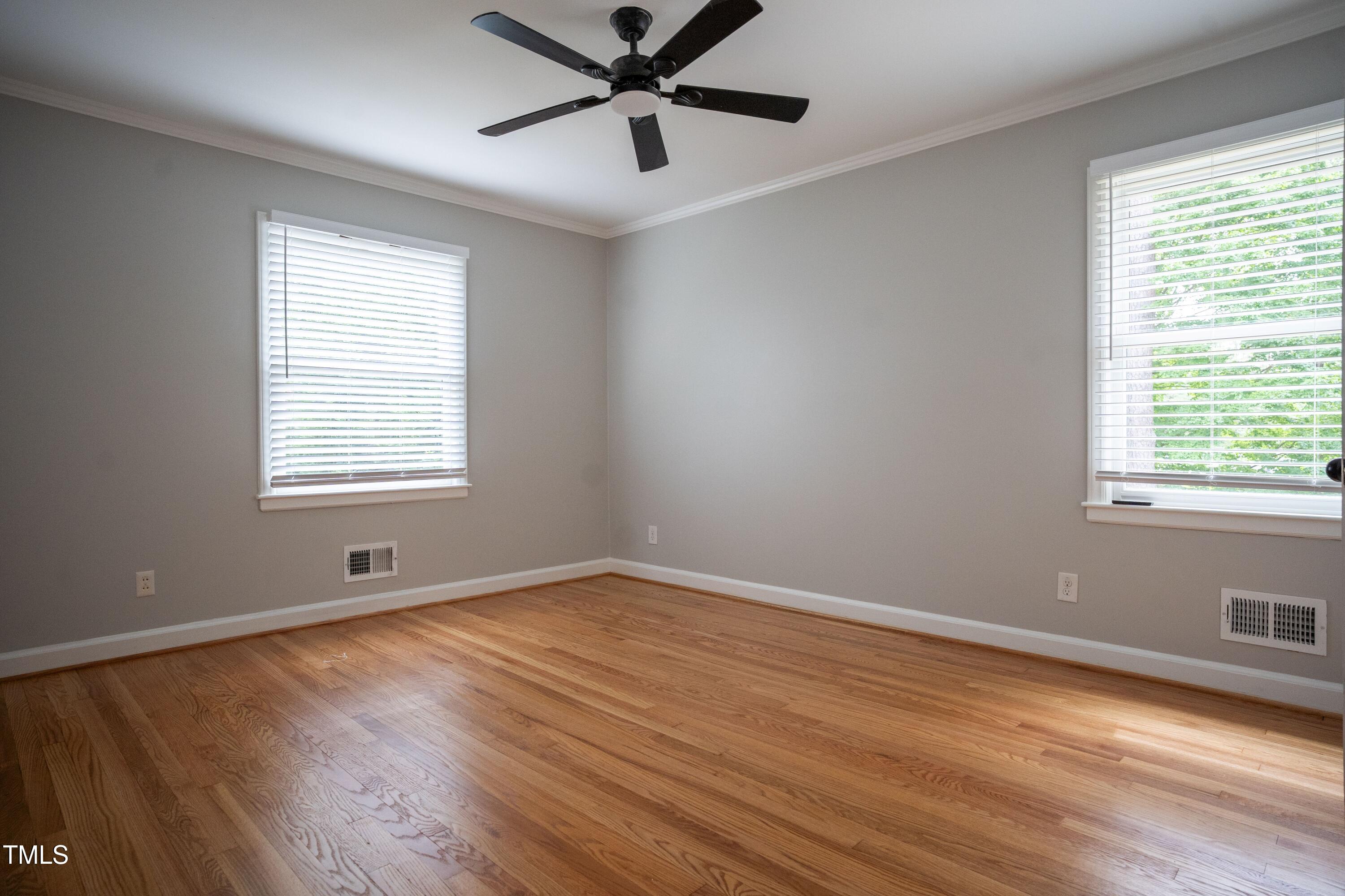 4813 Glen Forest Drive Raleigh, NC 27612 - Photo 16 of 39 a view of an empty room with wooden floor and a window