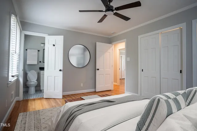 a bedroom with a bed and a painting on the wall