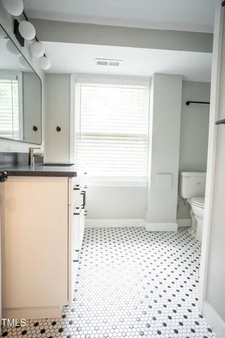 a bathroom with a shower and toilet