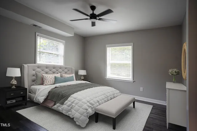 an empty room with wooden floor closet and windows