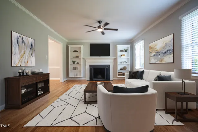 a living room with furniture a flat screen tv and a fireplace