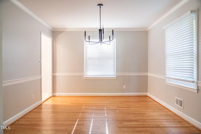 a view of a room with wooden floor and windows