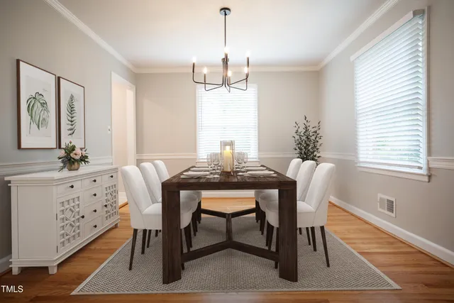 a dining room with furniture a rug and wooden floor