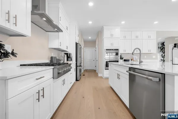 a large kitchen with stainless steel appliances lots of counter space sink and cabinets