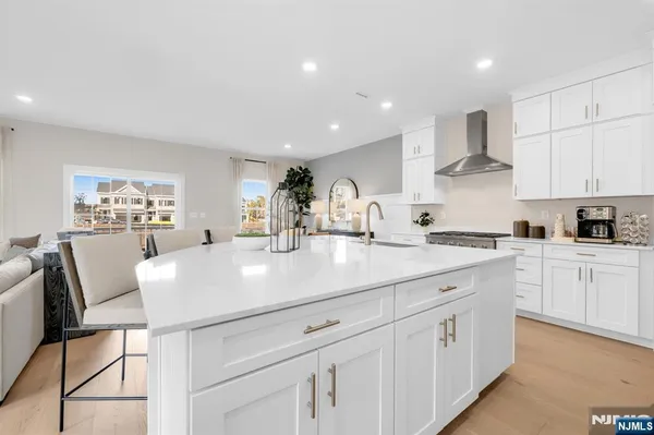 a kitchen with kitchen island white cabinets and white appliances