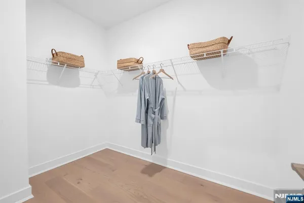 a view of room with stairs and wooden floor