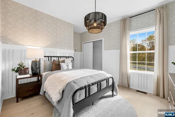 a bedroom with a bed and window