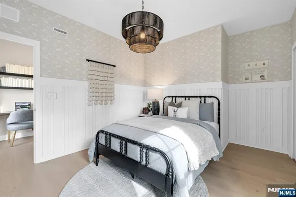 a bedroom with a bed and chandelier
