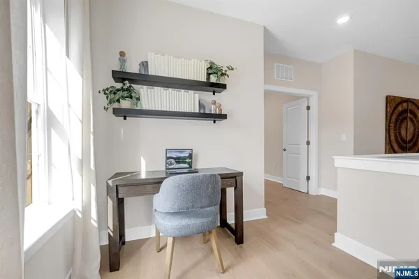 a kitchen with stainless steel appliances a table and chairs in it