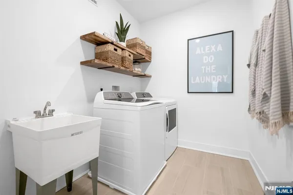 a white sink sitting next to a white cabinet