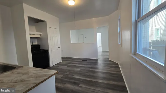 a view of hallway with wooden floor