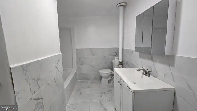 a view of bathroom with a sink and mirror