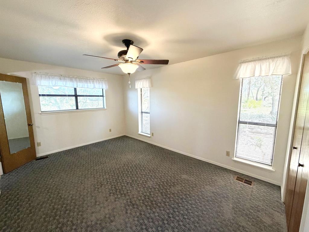 707 Rimrock Road Kerrville, TX 78028 - Photo 42 of 55 an empty room with windows and fan