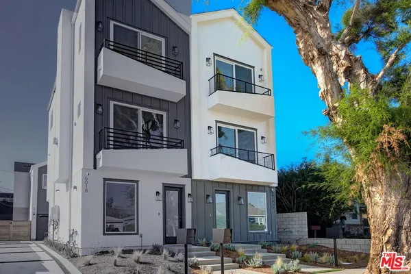 a front view of a building with parking space