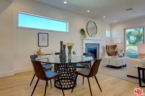 a view of a dining room with furniture and a fireplace