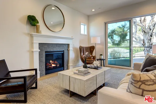 a living room with furniture a window and a fireplace