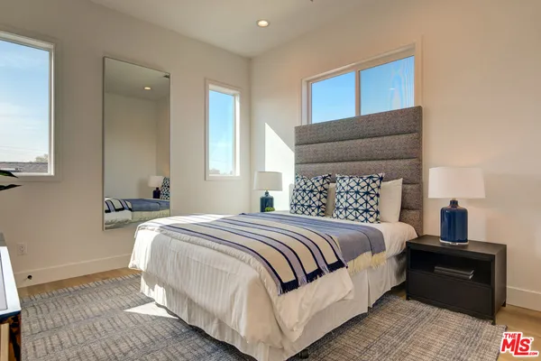 a bedroom with a bed and a night stand