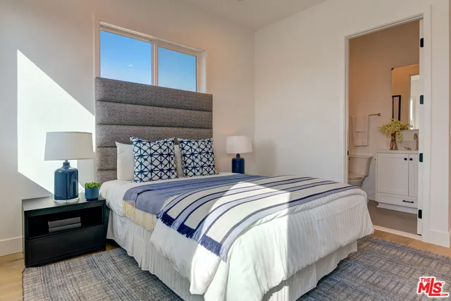 a bedroom with a bed and a night stand